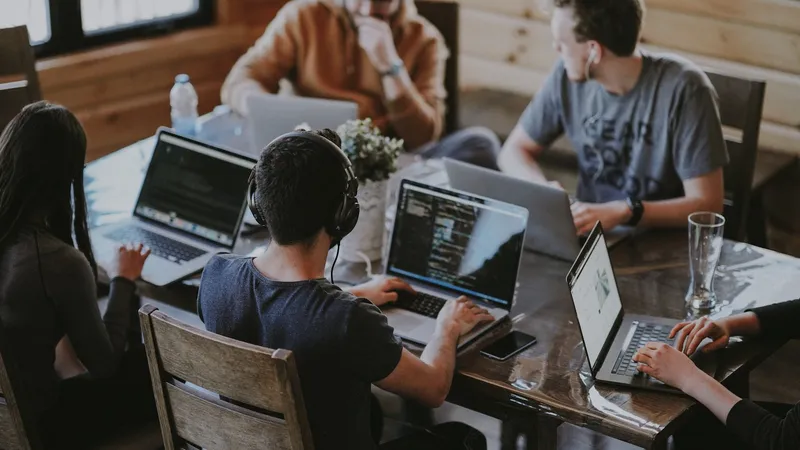 Distributed open-source development team collaborating on code, illustrating how community-driven projects scale into venture-backed businesses