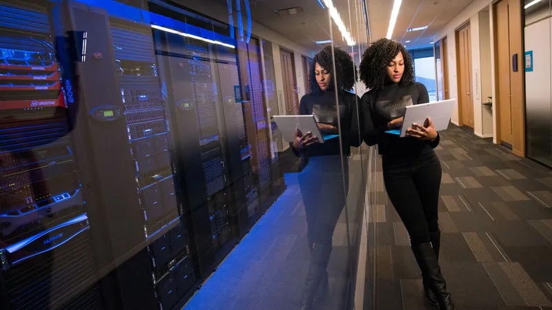 WDM Docker Manager operator using a laptop beside server racks for self-hosted Docker stack management